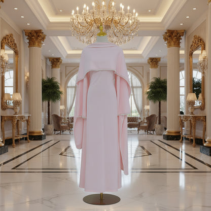 Pink dress on a mannequin with a vase of dried plants in a minimalistic setting