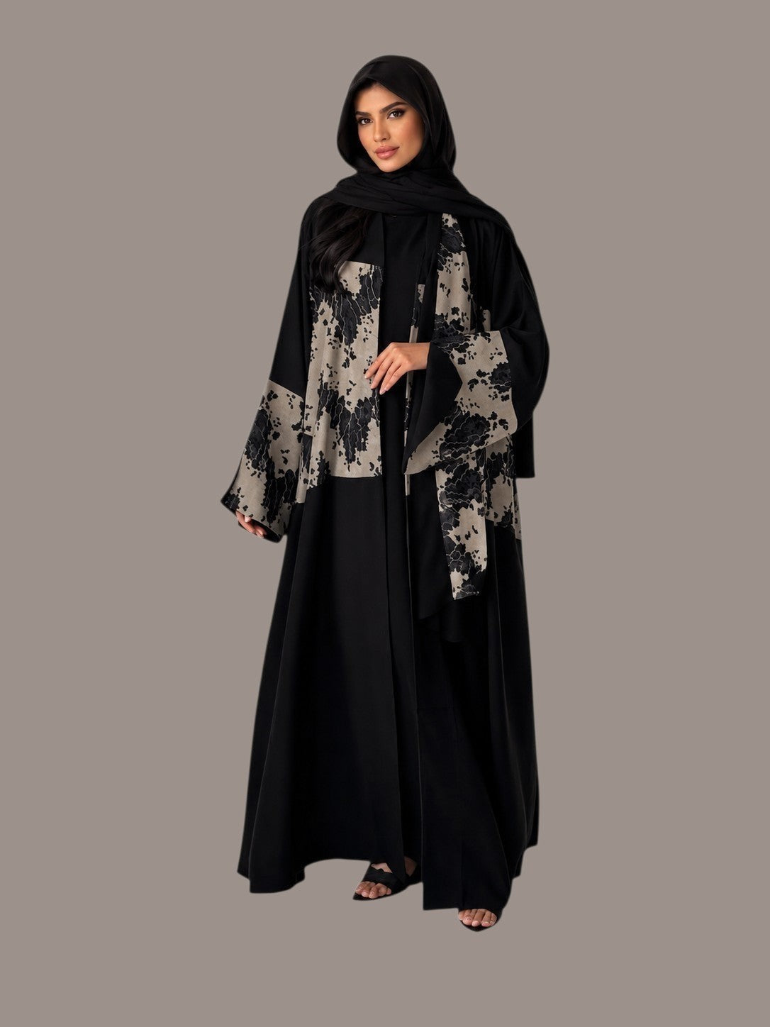 Anab Abaya 2-piece black abaya set with a flowing silhouette and contrasting floral patterned front and sleeves.