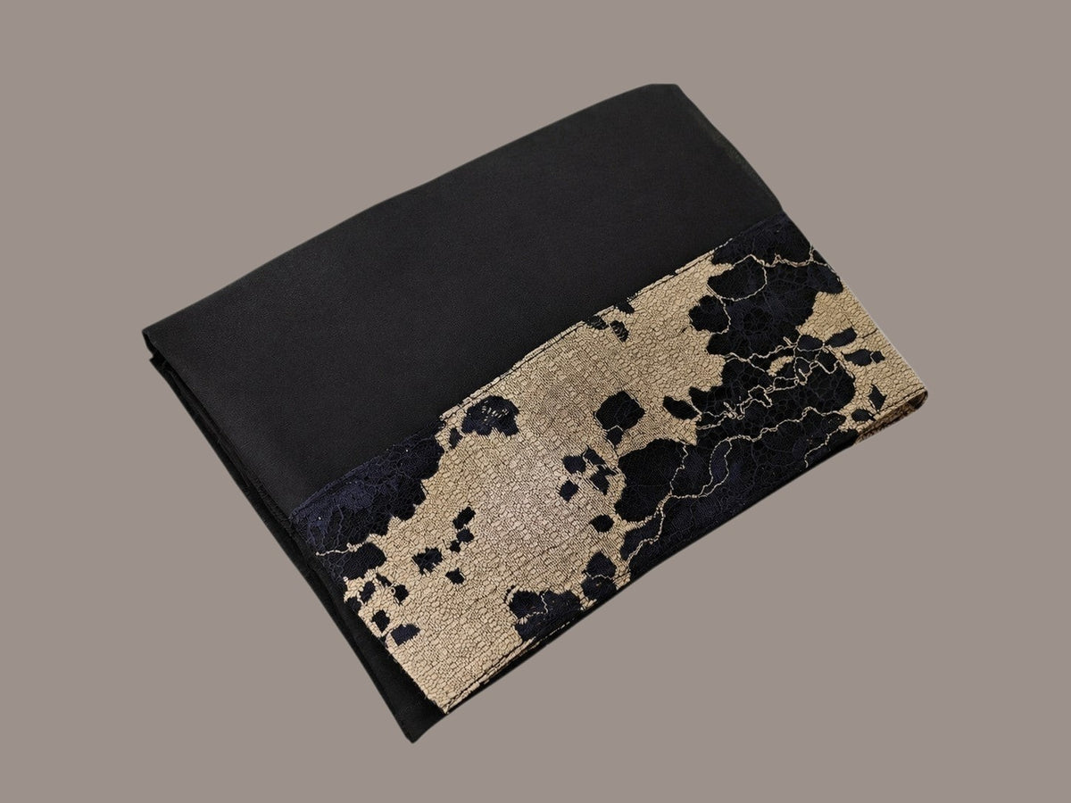 Anab Abaya 2-piece set featuring a black long dress with a sophisticated gold and black patterned lace detail