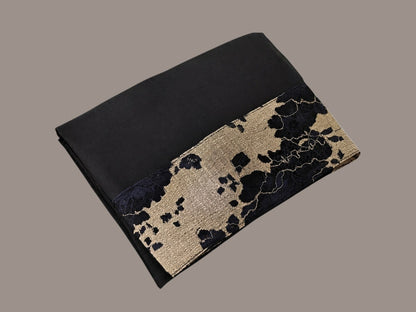 Anab Abaya 2-piece set featuring a black long dress with a sophisticated gold and black patterned lace detail